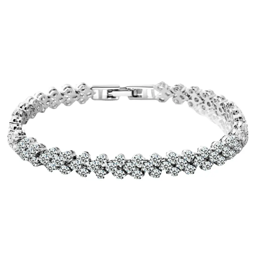 A silver bracelet with white stones on it.