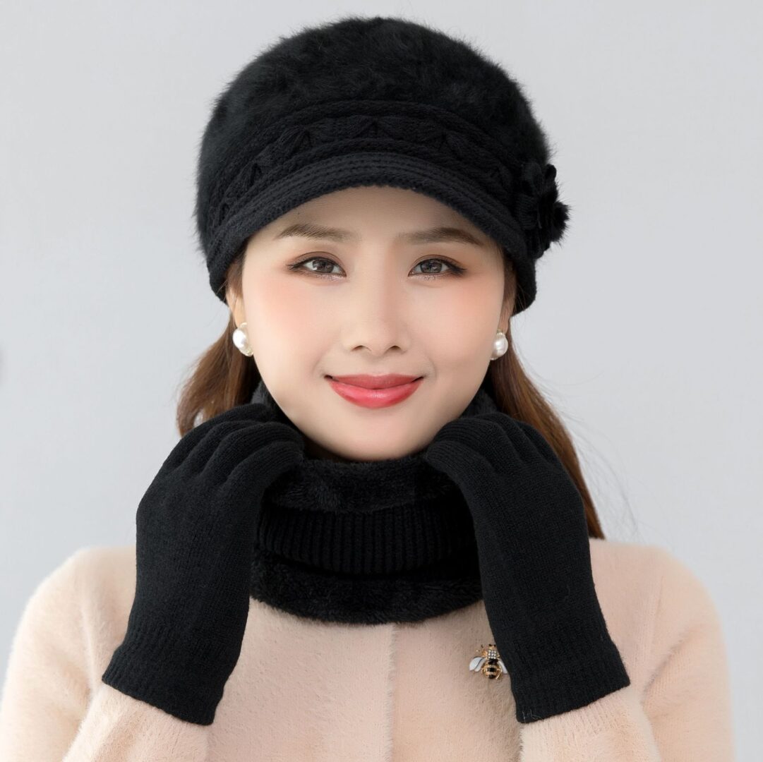 A woman wearing a hat, gloves and scarf.