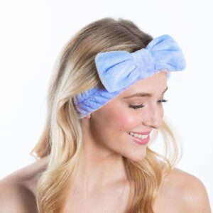 A woman with blonde hair wearing a blue bow headband.