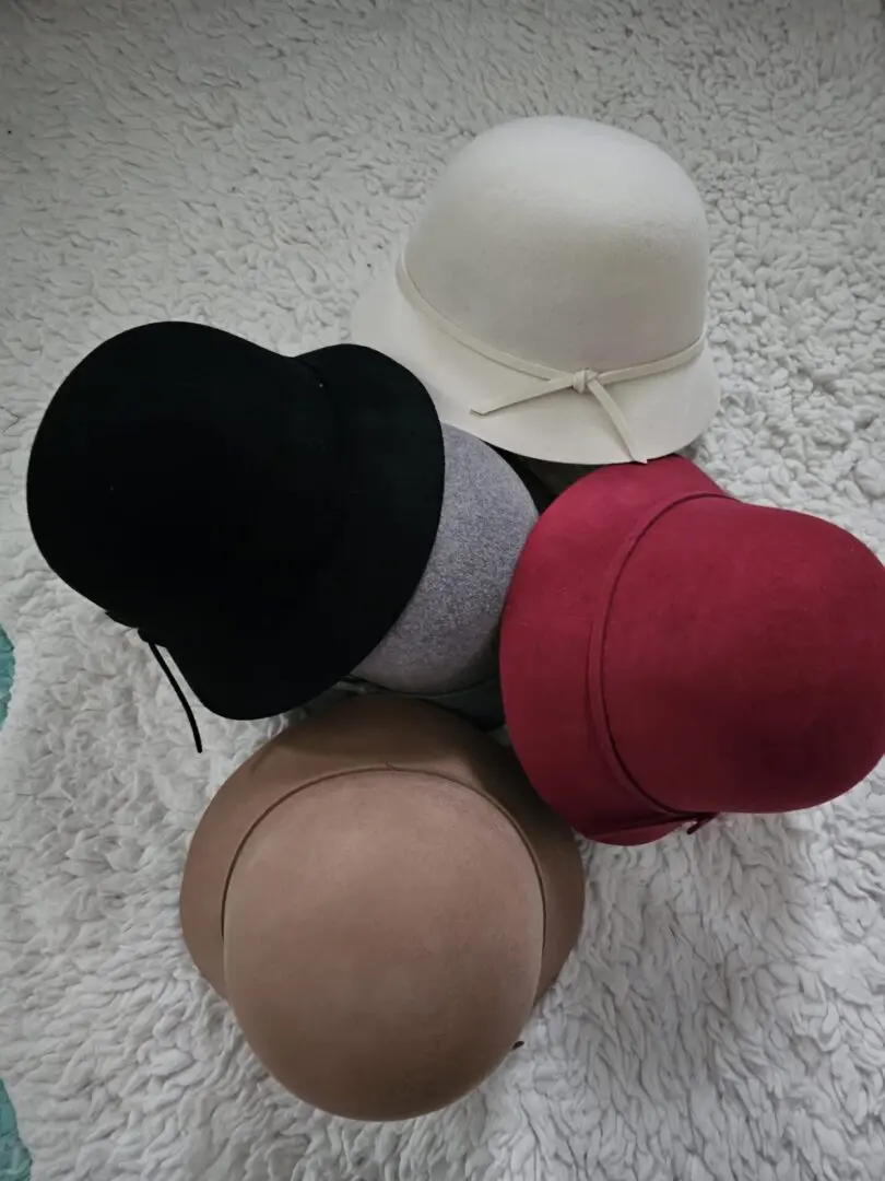 A group of hats sitting on top of a pile of fur.