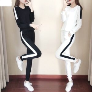 Two women are posing for a picture in their matching outfits.