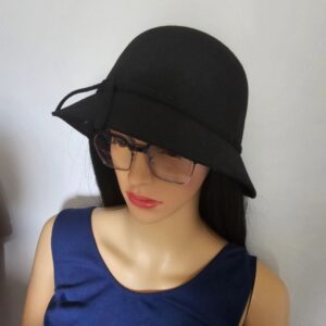 A mannequin wearing glasses and a black hat.