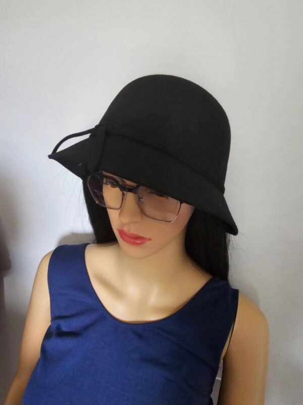 A mannequin wearing glasses and a black hat.