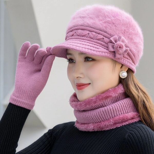 A woman wearing a pink hat and gloves.