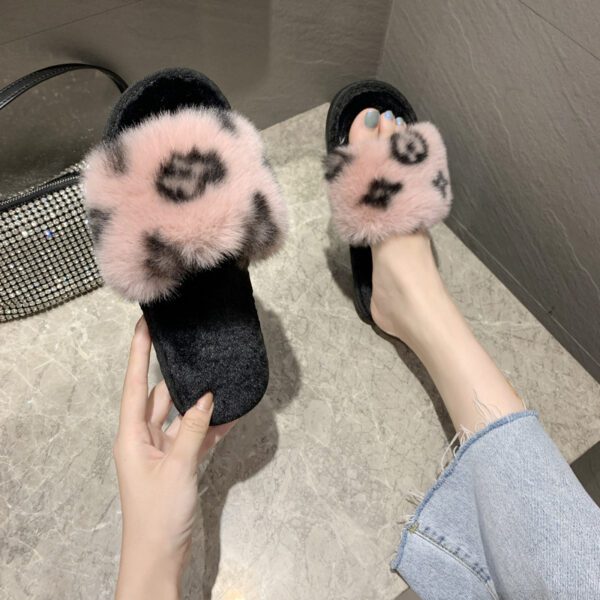 A person wearing furry slippers on the floor