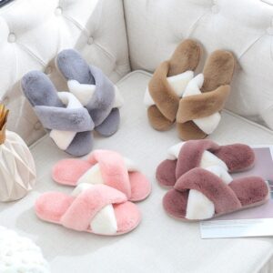 A group of four pairs of slippers sitting on top of a table.