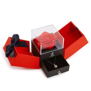 A red rose in a box with a necklace.