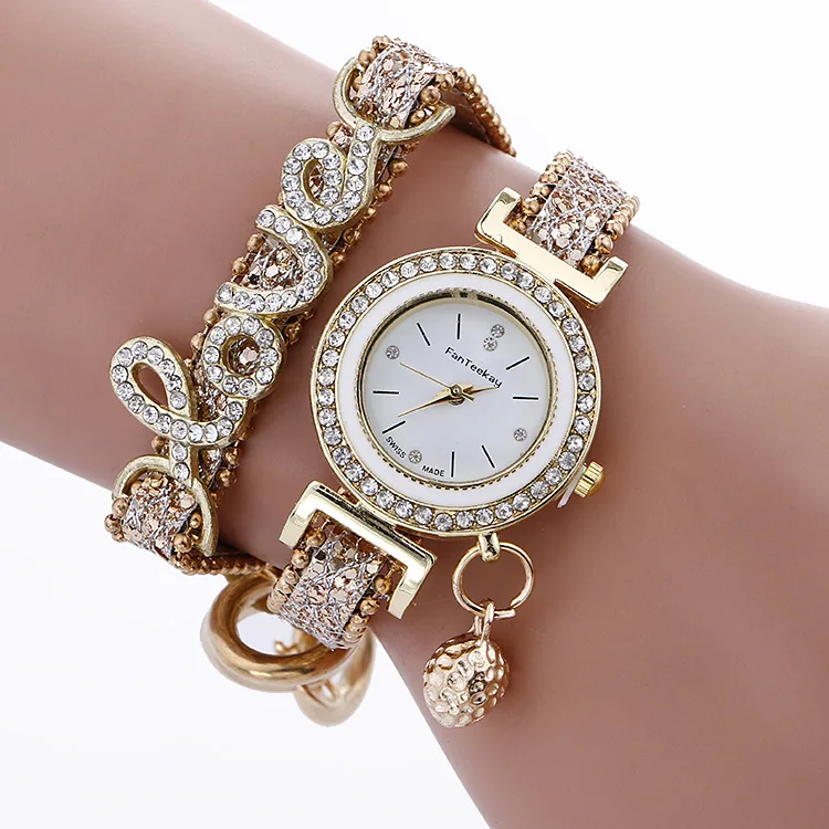 A gold watch with a bracelet on it